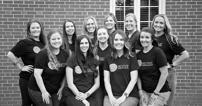 The Revive Integrative Health team posing together in matching shirts